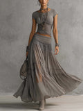 Conjunto Elena com top de painéis de renda e saia maxi plissada