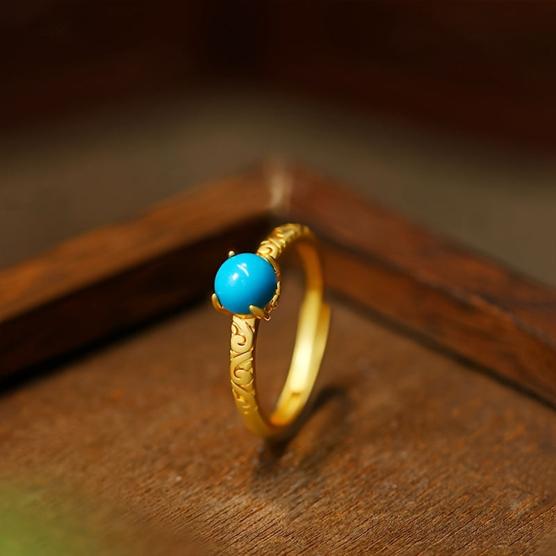 Elegante anillo dorado de banda con piedra de turquesa lisa