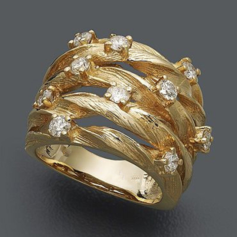 Elegante anillo de banda con circonitas, en forma de estrella dorada y enredadera sinuosa