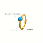 Elegante anillo dorado de banda con piedra de turquesa lisa