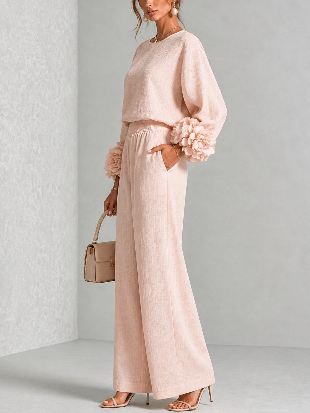 Side view of pink sweater set showing the ruffled cuff and relaxed wide leg pants